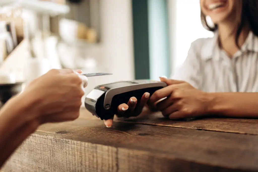 Person making a credit card purchase at a cafe
