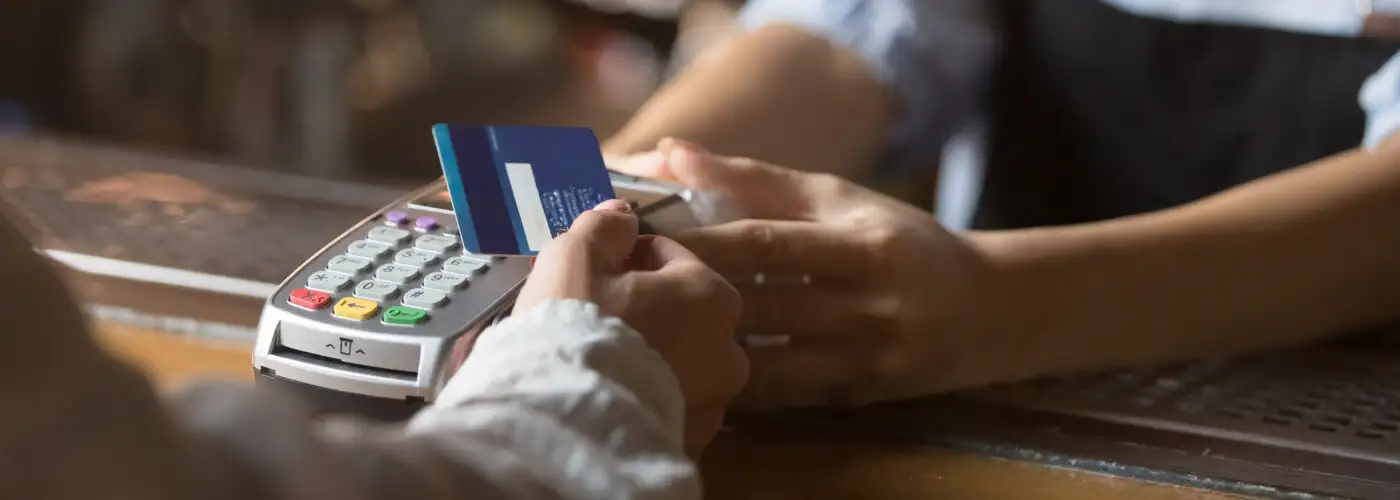 Close up of person scanning a blue credit card
