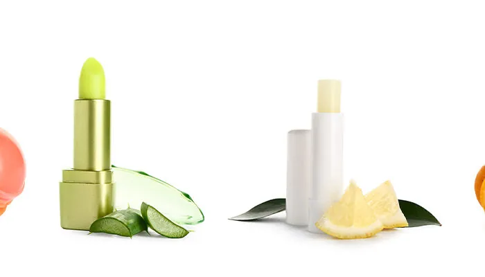 Set of different lip balms on white background
