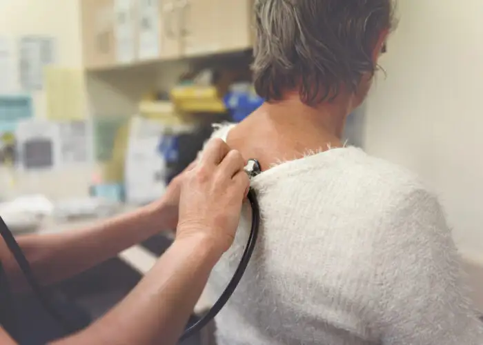 woman at doctors office with pre-existing condition travel insurance