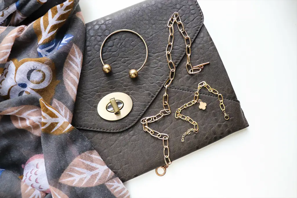 women's accessories. leather handbag, light scarf and jewelry
