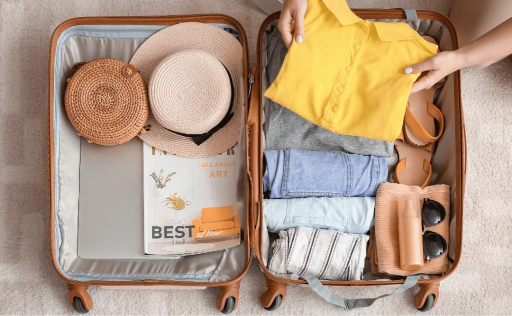 Woman packing suitcase at home. Travel concept