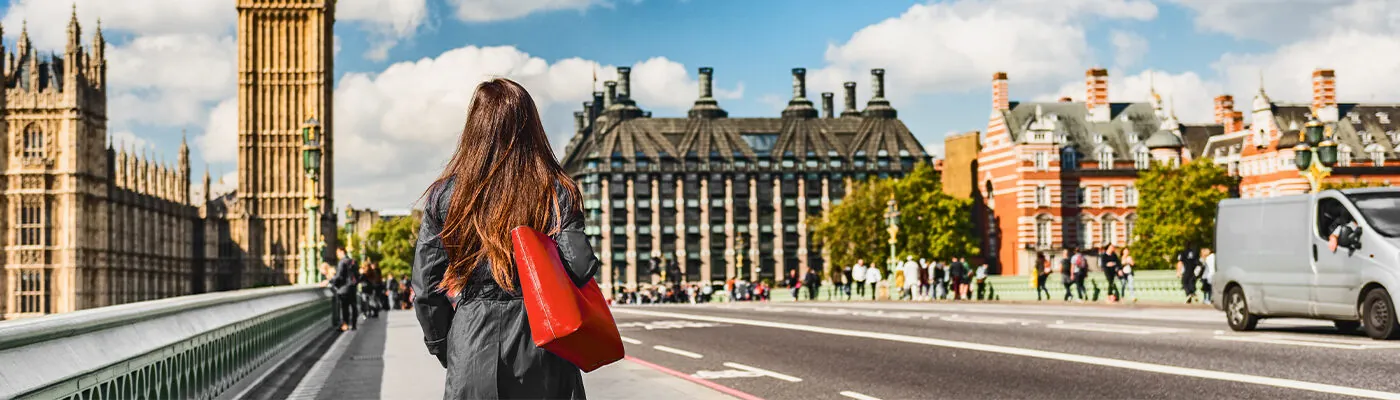 Woma walking in London near Big Ben